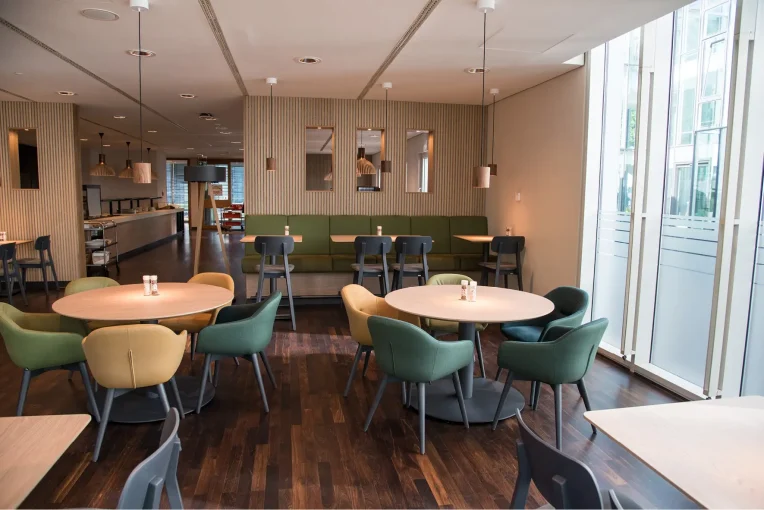 Möblierung, Stühle, Sessel Polsterbänke, Säulentische, Barhocker Campus-Restaurant Franz Haniel Duisburg, Schniedersitzt